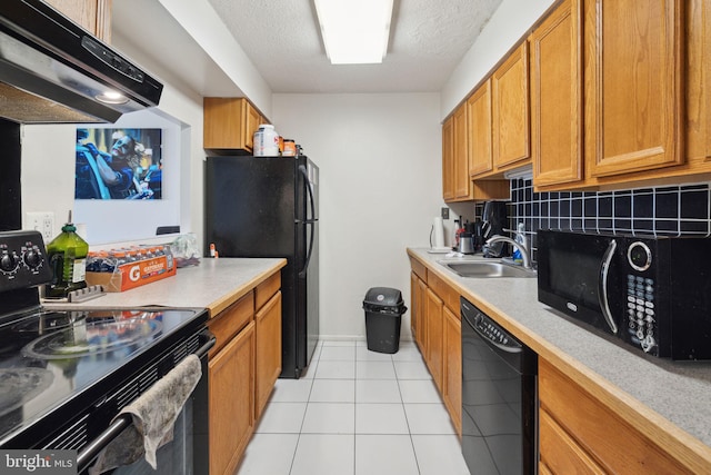 kitchen featuring backsplash, light tile floors, sink, ventilation hood, and black appliances