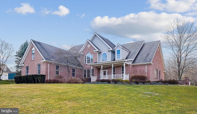 view of front property featuring a front lawn and covered porch