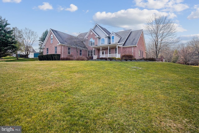 front facade with covered porch and a front lawn