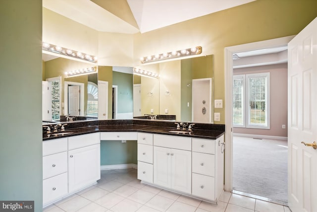 bathroom with dual bowl vanity and tile floors