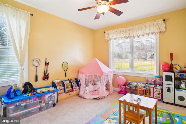 game room with light colored carpet and ceiling fan