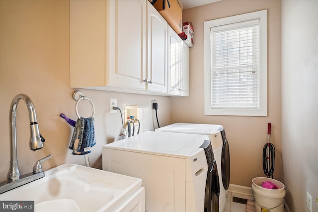 laundry area with hookup for a washing machine, hookup for an electric dryer, cabinets, tile floors, and washer and clothes dryer