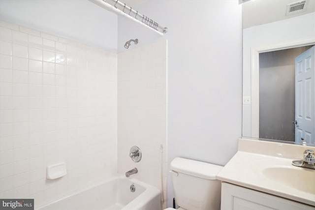 full bathroom with vanity, toilet, and tiled shower / bath