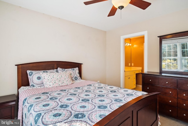 carpeted bedroom featuring ensuite bath and ceiling fan