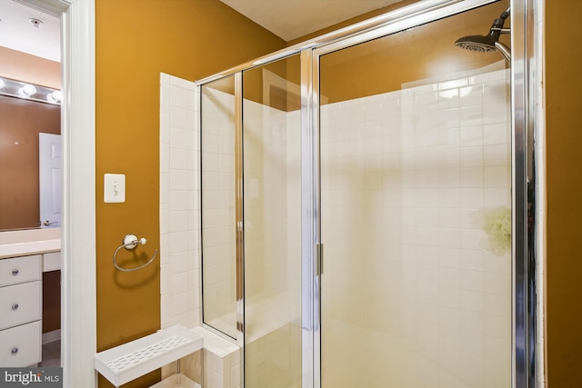 bathroom with an enclosed shower and vanity