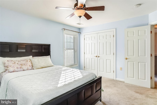 carpeted bedroom with a closet and ceiling fan