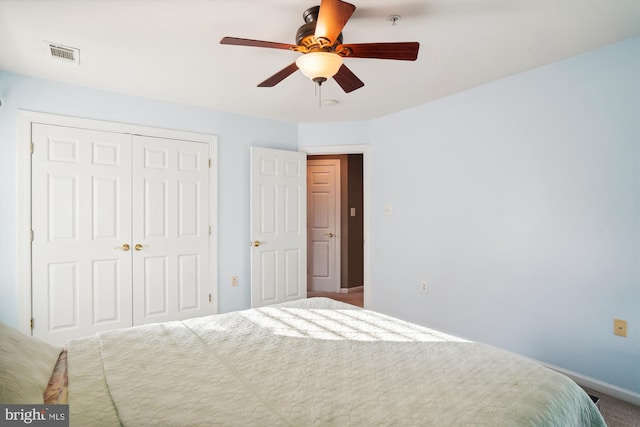 carpeted bedroom with a closet and ceiling fan