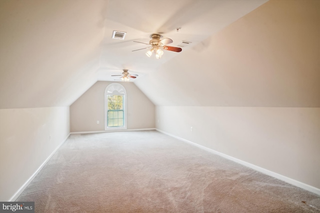 additional living space featuring light carpet, ceiling fan, and lofted ceiling