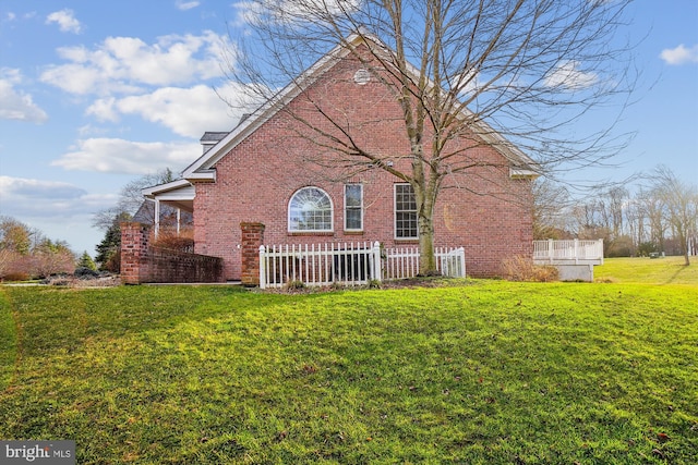 view of side of home featuring a yard