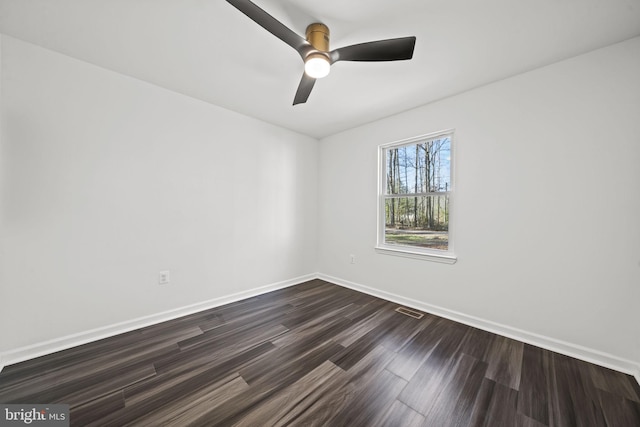 unfurnished room featuring dark hardwood / wood-style flooring and ceiling fan