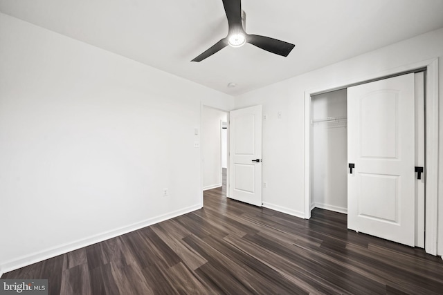 unfurnished bedroom with dark hardwood / wood-style floors, a closet, and ceiling fan