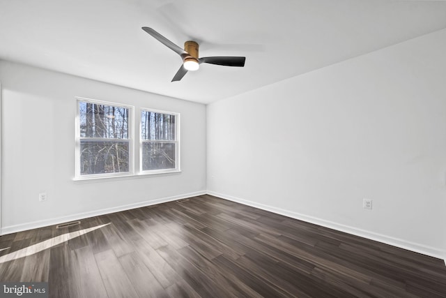 empty room featuring dark hardwood / wood-style flooring and ceiling fan