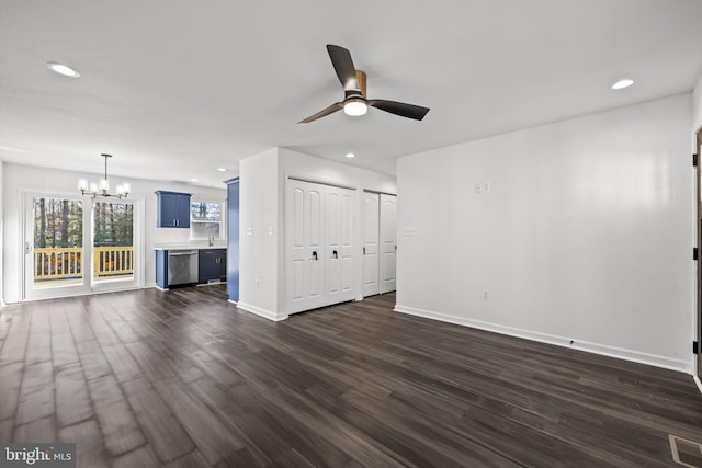 unfurnished living room with sink, dark hardwood / wood-style floors, and ceiling fan with notable chandelier