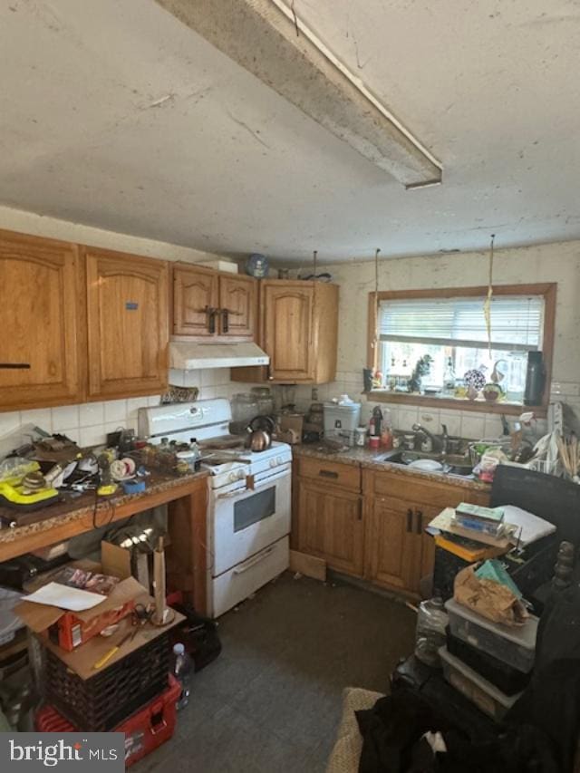 kitchen featuring sink and white stove