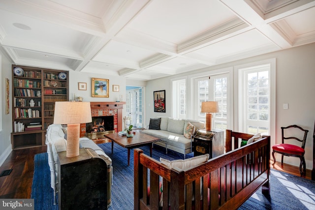 living room featuring coffered ceiling, a fireplace, dark wood-type flooring, and beam ceiling