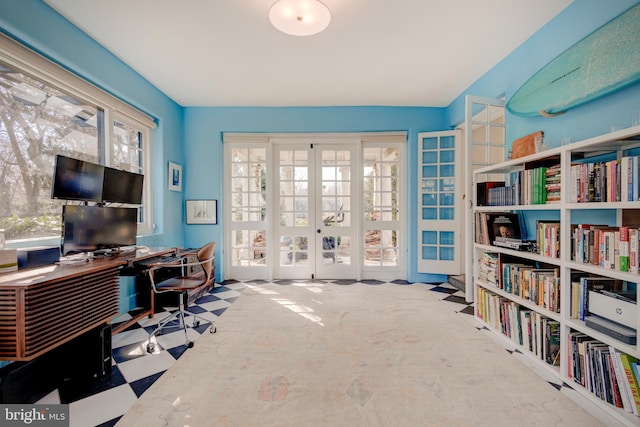 office area featuring a healthy amount of sunlight, light colored carpet, and french doors