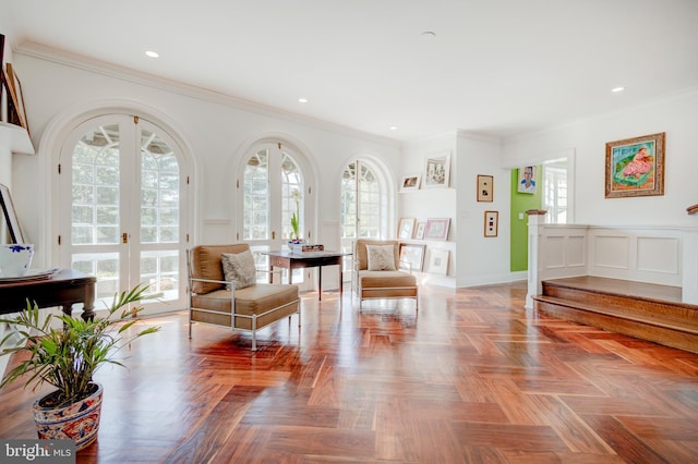 living area with parquet floors, french doors, and crown molding