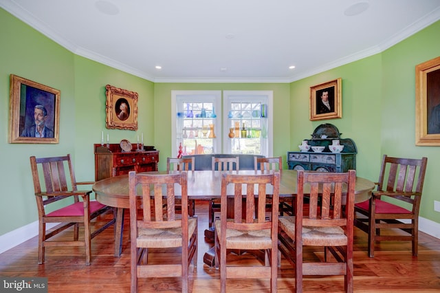 dining room featuring dark hardwood / wood-style flooring and crown molding