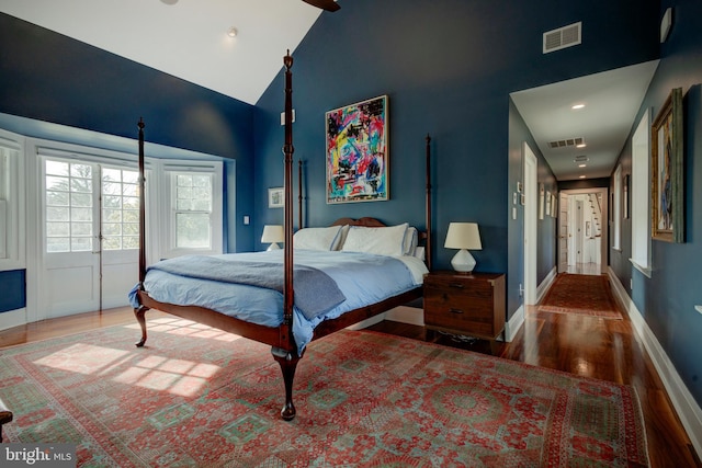 bedroom featuring high vaulted ceiling, french doors, and dark wood-type flooring