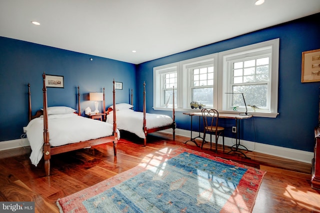 bedroom with dark hardwood / wood-style flooring