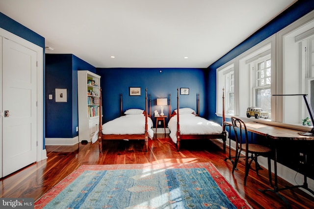 bedroom with dark hardwood / wood-style floors