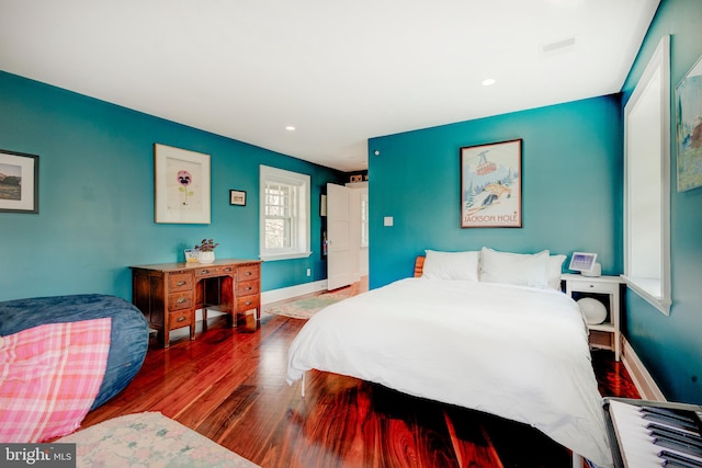 bedroom with dark hardwood / wood-style floors