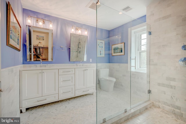 bathroom featuring tile flooring, toilet, dual bowl vanity, tile walls, and an enclosed shower