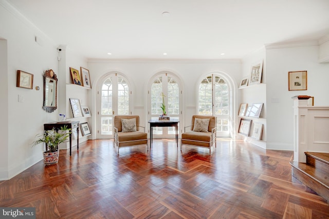 living area with plenty of natural light, ornamental molding, and dark parquet floors