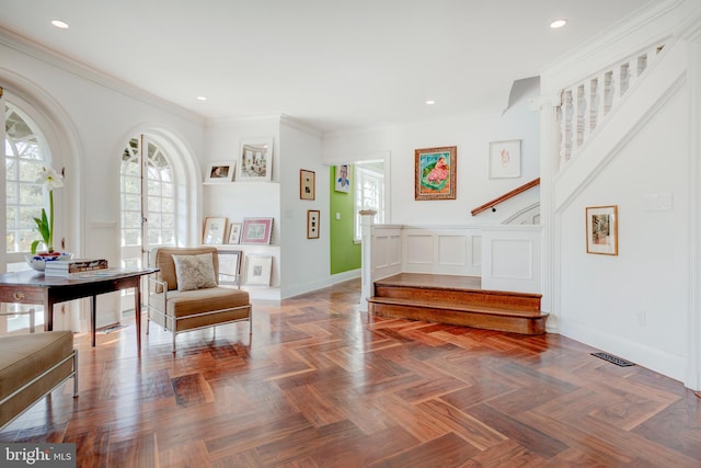 foyer with crown molding and parquet floors