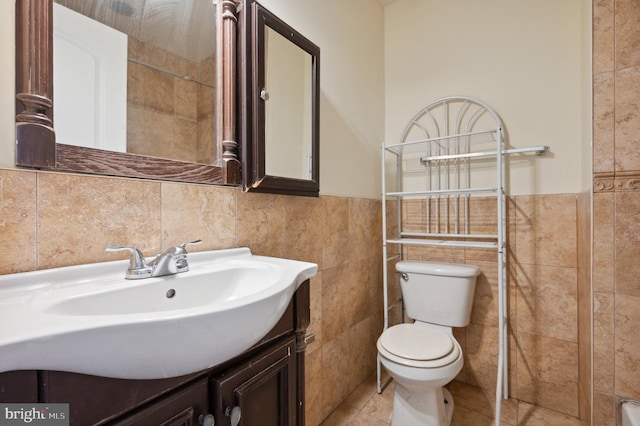 bathroom with tile walls, tile floors, toilet, tasteful backsplash, and large vanity