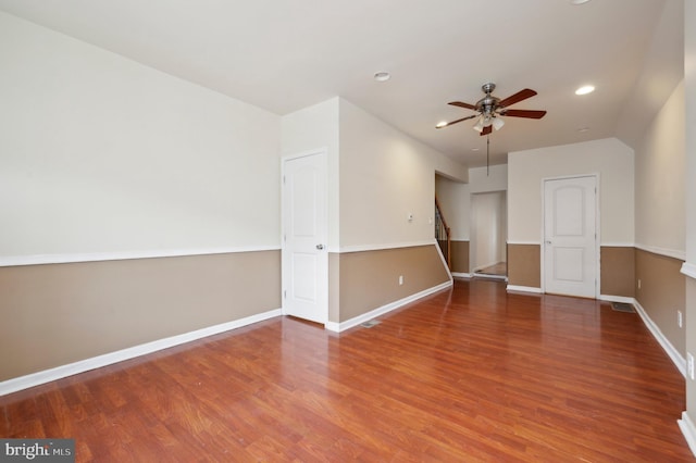 spare room featuring ceiling fan and dark wood-type flooring