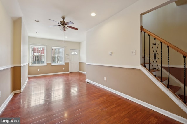 spare room with ceiling fan and dark wood-type flooring