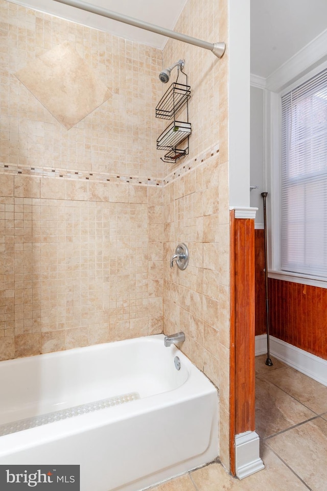 bathroom with tiled shower / bath combo and tile flooring