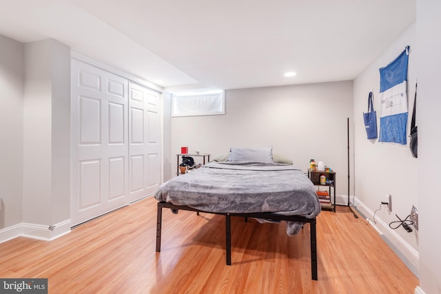 bedroom featuring a closet and light wood-type flooring