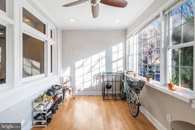 sunroom / solarium featuring ceiling fan and a wealth of natural light