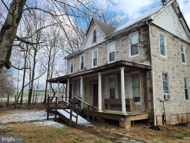 rear view of property featuring a porch