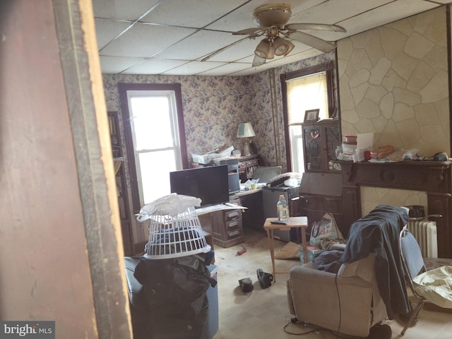 misc room featuring a paneled ceiling, ceiling fan, and a wealth of natural light