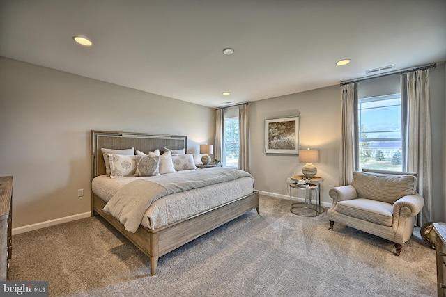 carpeted bedroom featuring multiple windows