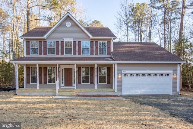 view of front of property featuring covered porch and a garage