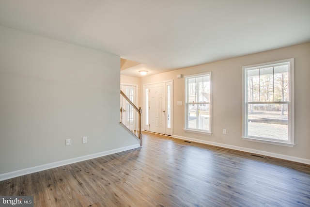 empty room with hardwood / wood-style flooring