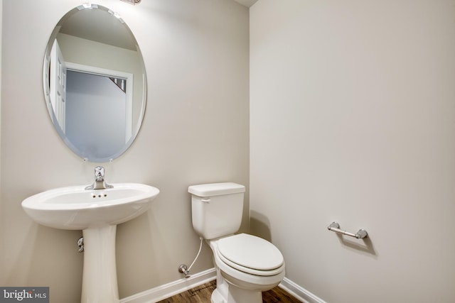 bathroom featuring toilet and hardwood / wood-style flooring