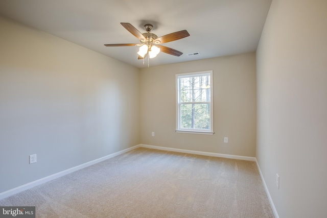 unfurnished room with light colored carpet and ceiling fan