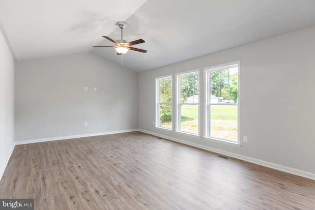 unfurnished room with ceiling fan, lofted ceiling, and light hardwood / wood-style flooring