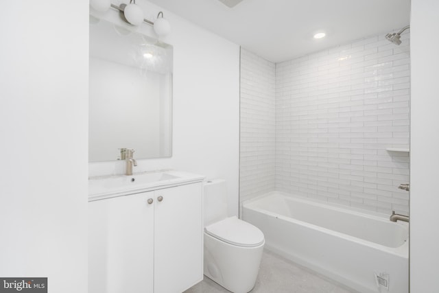 full bathroom featuring vanity, tiled shower / bath combo, and toilet