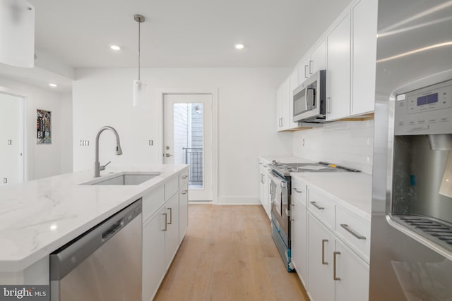 kitchen featuring sink, white cabinets, light hardwood / wood-style flooring, and appliances with stainless steel finishes