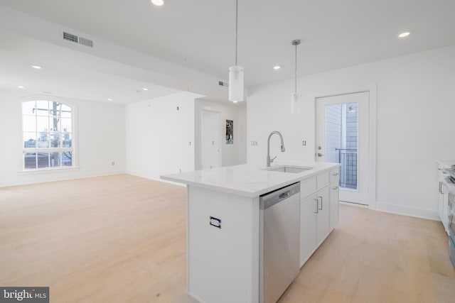 kitchen featuring light hardwood / wood-style flooring, stainless steel dishwasher, decorative light fixtures, a kitchen island with sink, and white cabinets