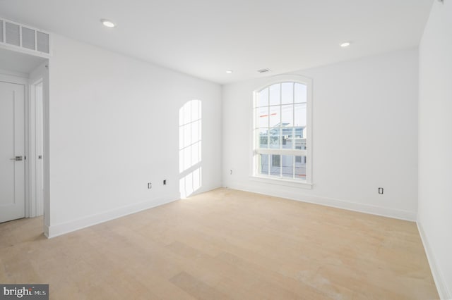 spare room featuring light wood-type flooring