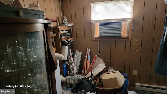 miscellaneous room featuring wood walls and a baseboard radiator