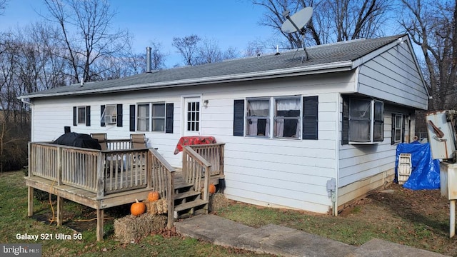 rear view of property with a wooden deck