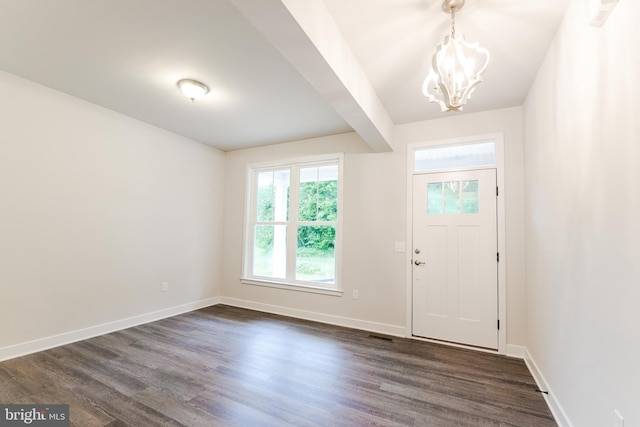 entryway with an inviting chandelier and dark hardwood / wood-style flooring